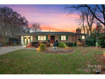 Brick ranch home with landscaped yard and fountain at 663 14Th Nw Ave, Hickory, NC 28601