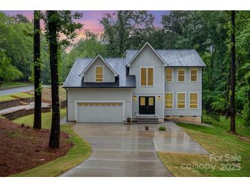 Charming two-story home featuring a modern design, two-car garage, and a long driveway at 10221 Hanging Moss Trl, Mint Hill, NC 28227