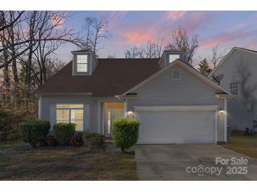 Charming home with dormer windows, manicured bushes and a two-car garage at 6707 Brachnell View Dr, Charlotte, NC 28269