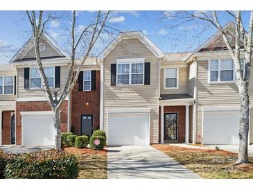 Charming townhouse featuring a one-car garage and well-maintained landscaping at 7122 Abbotts Glen Dr, Charlotte, NC 28212