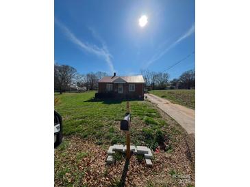 Brick ranch house with a metal roof and a spacious yard at 111 James Love School Rd, Shelby, NC 28152