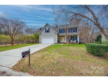 Charming two-story home with a well-manicured lawn and inviting front porch at 1345 Shimmer Light Cir, Rock Hill, SC 29732