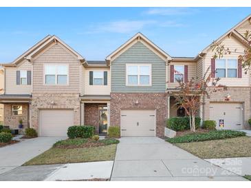 Brick front of charming townhome with two-car garage and landscaping at 236 Ascot Run Way, Fort Mill, SC 29715