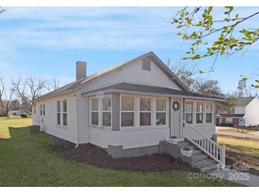 Charming renovated bungalow with a welcoming front porch and landscaped yard at 304 Gold Hill Ave, Rockwell, NC 28138