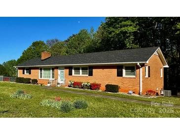 Charming brick home with lush front yard and inviting entrance and well maintained landscape at 2319 Tin Mine Rd, Lincolnton, NC 28092