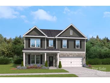 Charming two-story home with stone accents, a well-manicured lawn and attractive landscaping at 320 Coronado Ave, Matthews, NC 28104