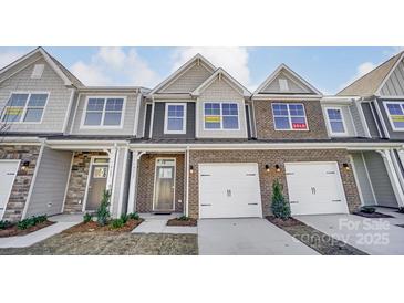 Three-unit townhome building, two units available. Brick and siding exterior, two-car garages at 4113 Black Ct # 167, Harrisburg, NC 28075