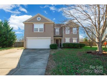 Charming two-story home featuring a well-manicured front yard and a two-car garage, perfect for a growing Gathering at 1114 Fenwick Ct, Clover, SC 29710