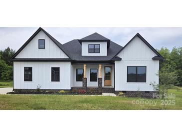 Charming new construction home featuring white siding, black trim and roof, and a welcoming front porch at 1215 Coppergate Dr, Salisbury, NC 28147
