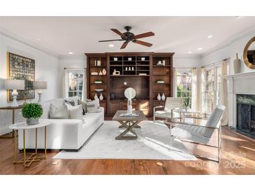 Bright living room features hardwood floors, custom built-ins, and neutral decor at 13101 Whisper Creek Dr, Charlotte, NC 28277