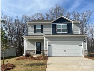 Charming two-story home featuring stone accents, a two-car garage, and a beautifully landscaped front yard at 3250 Maple Ridge Dr, Gastonia, NC 28052