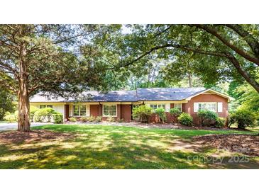 Charming brick home featuring a well-maintained lawn, inviting curb appeal, and a classic architectural design at 829 Rawlinson Rd, Rock Hill, SC 29732