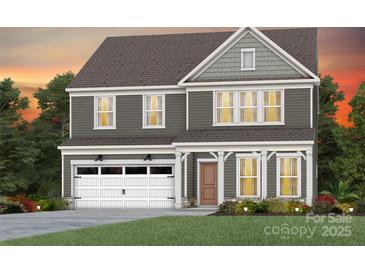 Two-story house with gray siding, white garage door, and landscaping at 13732 Roderick Dr # 170, Huntersville, NC 28078