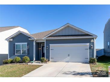 Ranch style home with gray siding, two car garage, and landscaped lawn at 138 Gray Willow St, Mooresville, NC 28117