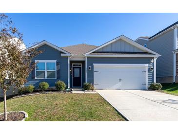 Charming single-story home featuring a two-car garage, manicured lawn, and classic architectural details at 138 Gray Willow St, Mooresville, NC 28117