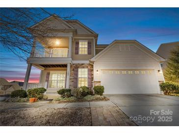 Two-story house with beige siding, a large garage, and landscaping at 160 Millen Dr, Mooresville, NC 28115