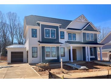 Two-story home featuring a mix of white and blue siding, complemented by dark window frames and a matching roof at 2003 Kendall Dr # 5, Wesley Chapel, NC 28173