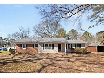 Charming one-story home with a metal roof, brick accents, and a well-maintained yard at 440 Providence Rd, Lancaster, SC 29720