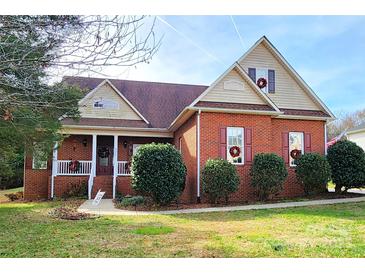 Brick home with a front porch and landscaped yard at 901 Huntington Hills Dr, Lincolnton, NC 28092