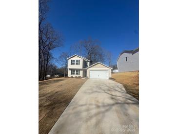 Charming two-story home with a spacious driveway and attached two-car garage at 1608 Cole St, Gastonia, NC 28054