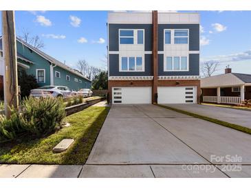 Modern two-story home featuring a concrete driveway, two-car garage, and contemporary design at 327 Coxe Ave, Charlotte, NC 28208