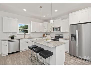 Modern kitchen with white cabinets, granite countertops, and stainless steel appliances at 4039 Northerly Island Ct, Gastonia, NC 28056