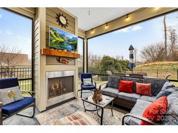 Relaxing screened porch with fireplace and seating area, perfect for outdoor living at 423 Granite Lake Ct, Denver, NC 28037