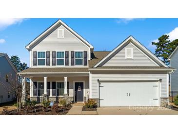 Two-story house with gray siding, stone accents, and a two-car garage at 4551 Selhurst Dr, Indian Land, SC 29707