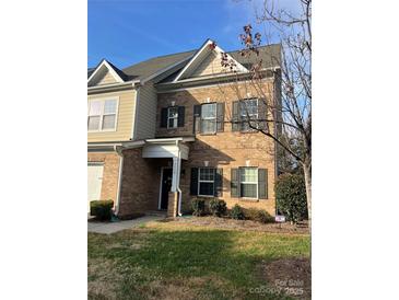 Brick front exterior of charming two-story townhome with landscaping at 5110 Pansley Dr, Charlotte, NC 28226