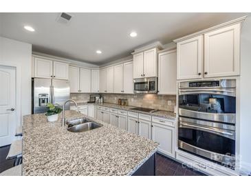 Spacious kitchen with stainless steel appliances and granite countertops at 5110 Pansley Dr, Charlotte, NC 28226