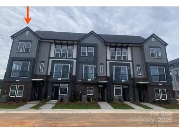 Modern townhome exteriors with large windows and brick accents for stylish curb appeal at 1324 Walter Taylor Way # Eqx0101, Charlotte, NC 28206