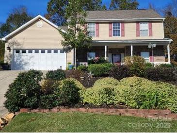 Two-story house with attached garage and landscaped front yard at 12205 Westbury Glen Ct # 17, Charlotte, NC 28262