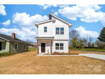 Charming two-story home with a modern design and a well-maintained front yard at 613 Buffalo St, Shelby, NC 28150