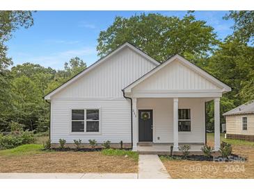 Charming white house with a welcoming front porch at 108 Elwood St, Kannapolis, NC 28081