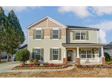 Two-story house with light beige siding, green shutters, and a landscaped front yard at 3028 Semmes Ln, Indian Trail, NC 28079