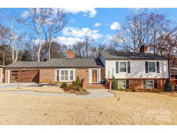 Brick ranch home with updated exterior and landscaping at 3335 Knob Hill Ct, Charlotte, NC 28210