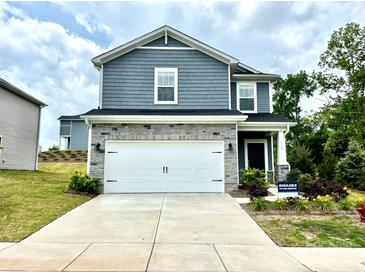 Charming two-story home featuring stone accents, a two-car garage, and a well-maintained front yard at 102 Alden Ct, Shelby, NC 28152