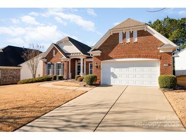 Brick ranch home with a two-car garage and well-manicured lawn at 41166 Calla Lily St, Fort Mill, SC 29707