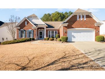 Brick front house with a two-car garage and landscaping at 41166 Calla Lily St, Fort Mill, SC 29707