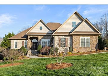 Brick and stone two-story house with landscaped lawn at 1076 Fox Chase Dr, Newton, NC 28658