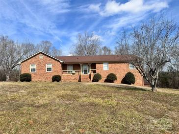 Brick ranch house with a large yard and attached garage at 16480 Indian Mound Rd, Norwood, NC 28128