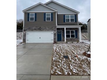 Charming two-story home with a stone and gray facade, blue shutters, and a two-car garage at 108 Rustling Waters Dr, Mooresville, NC 28117