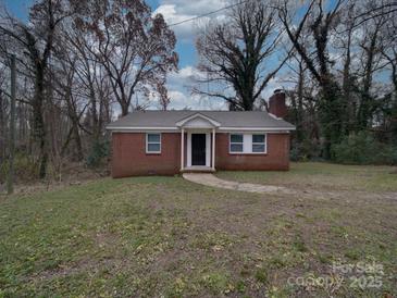 Brick ranch house with a walkway and grassy yard at 2996 Shady Ln, Charlotte, NC 28208