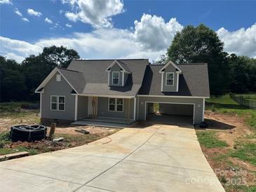 Charming new construction home featuring a gray exterior, dormer windows, and an attached two car carport at 184 Maplewood Ln, Taylorsville, NC 28681