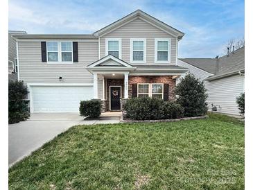 Two-story house with a stone facade, front porch, and attached garage at 3960 Farmington Ridge Pkwy, Charlotte, NC 28213