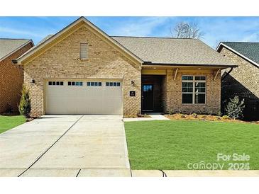 Charming brick home with a two-car garage, well-manicured lawn, and inviting front entrance at 409 Newstyle Way # 3, Cramerton, NC 28056