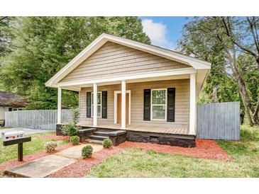 Charming craftsman home with gray siding, front porch, and landscaped yard at 612 Calvary St, Shelby, NC 28150