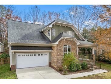 Charming home featuring stone accents, a covered porch, and a two-car garage at 7708 Spanish Oaks Dr, Waxhaw, NC 28173