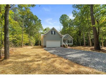 Gray house with a white garage door and landscaping at 2754 Crowders Creek Rd, Gastonia, NC 28052