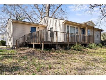 Beige ranch style house with large deck, backyard and blue front door at 503 N Boyce St, Gastonia, NC 28052